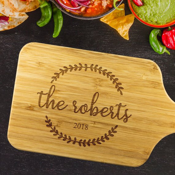 Personalized bamboo cutting board with family name displayed on kitchen counter | Mrs Gift