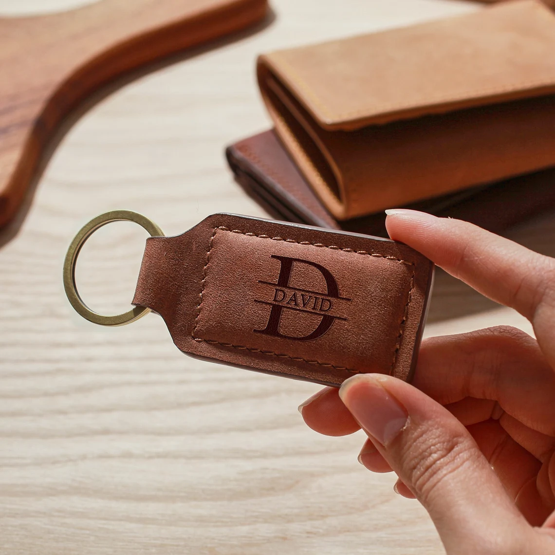 Hand holding a brown leather keychain engraved with name David – custom gift for husband or boyfriend | Mrs Gift