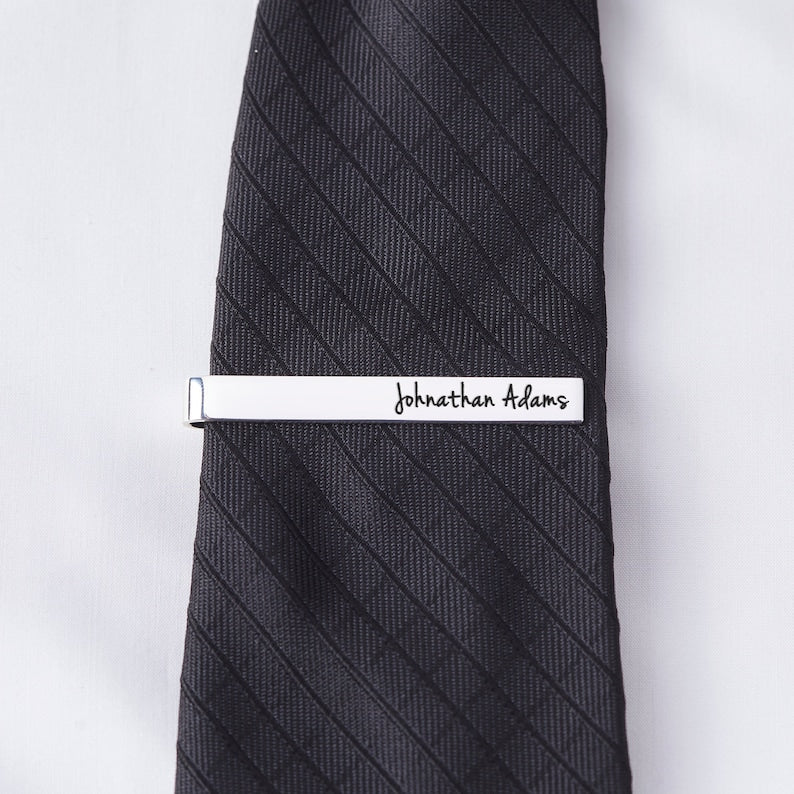 Custom silver tie clip engraved with Johnathan Adams on black tie | Mrs Gift