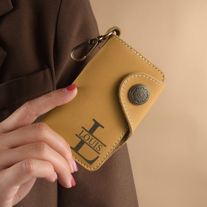 Person holding Mrs Gift personalized tan leather key wallet with custom monogram, showing practical everyday use